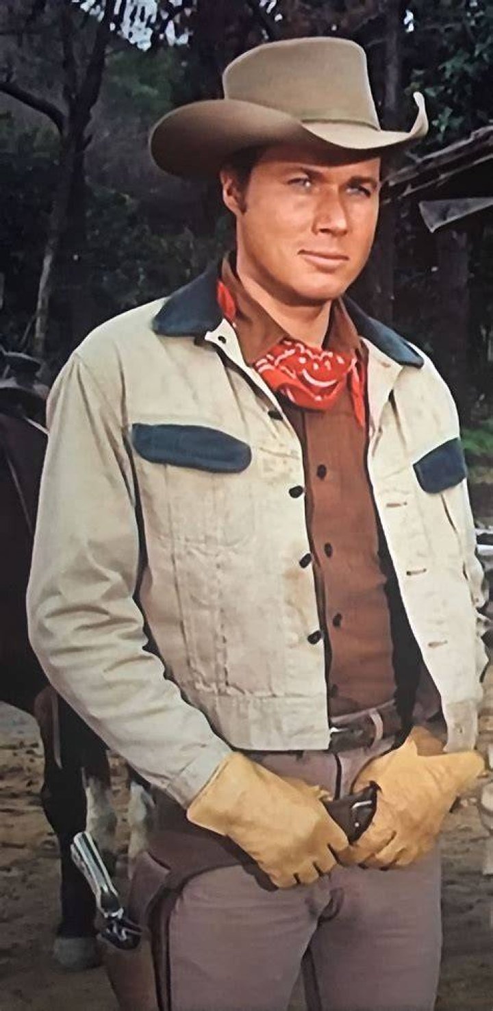 ..handsome rancher.. Yes he is John smith actor, John smith, Laramie