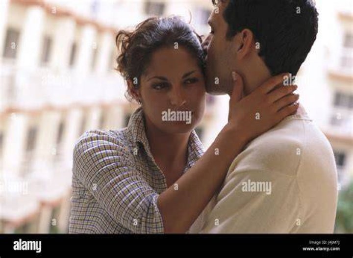 Woman, seriously, man, kiss, temple, half portrait, curled, balcony